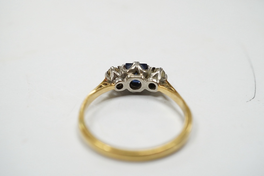 A yellow metal, sapphire and diamond set three stone ring, size Q, gross weight 3 grams. Condition - fair